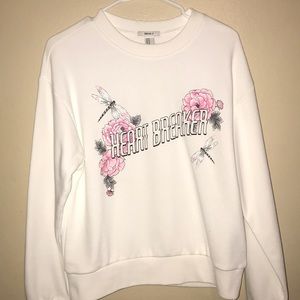 A crewneck that says heart breaker